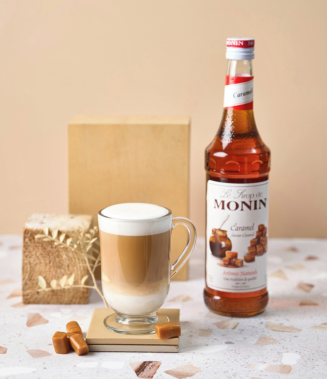 MONIN Caramel Syrup with a hot drink